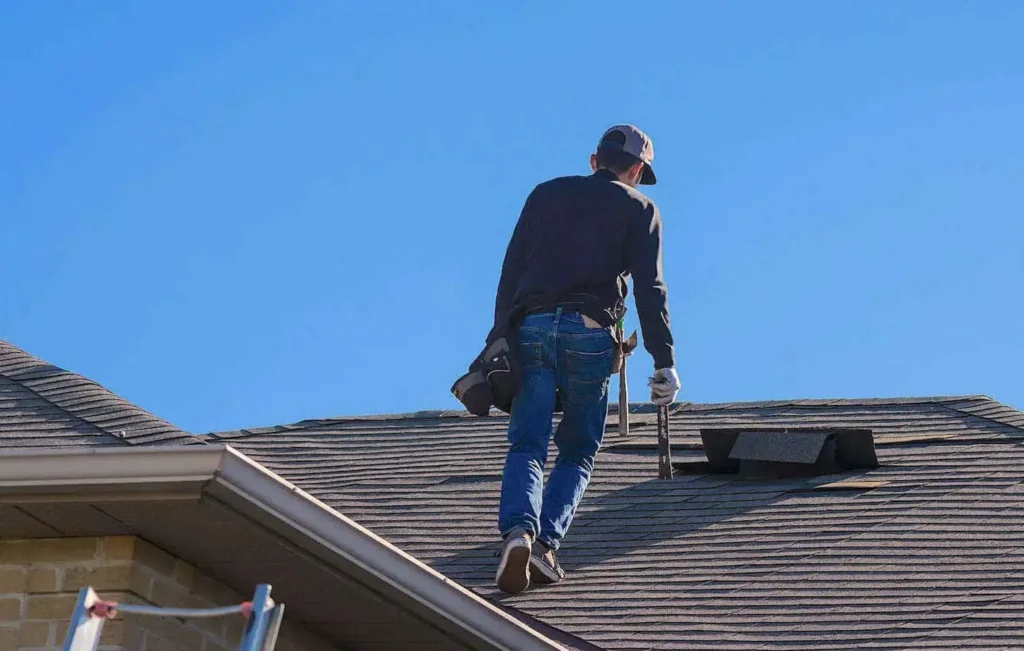 Roofer inspecting roof damage